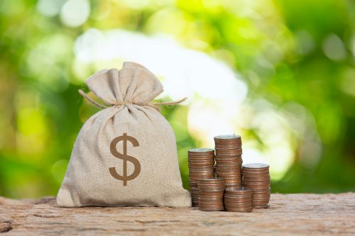 World Habitat Day,close up picture of a pile of coins and a sag of coin